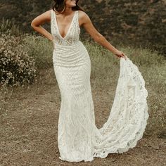 a woman in a white dress is posing for the camera