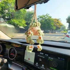 the interior of a car with flowers hanging from it's dash board and dashboard