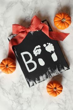 an orange pumpkins and some black paper with the word boo on it