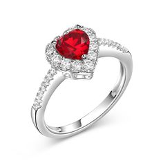 a red heart shaped ring with diamonds around it