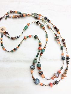 Two chunky, bold, earthy, well-traveled, strands. Perfect on linen, a statement piece for those who love military green and earthy orange-red. This piece includes quality gemstones like African Turquoise, Pyrite Jade, Pearls, Tibetan Agate, Opal, Labradorite, Jade, several Agates and Jaspers, Prehnite, Sponge Coral, Hematite, and more. Stones in a variety of sizes, finish, and texture. Mix in Bodhi Lotus beads, bone beads,  vintage Czech, Ancient Roman Glass, seed beads, mixed metals, colored co Adjustable Green Rustic Necklace, Adjustable Rustic Green Necklace, Bohemian Green Agate Necklaces, Earthy Multicolor Gemstone Beaded Necklaces, Earthy Multicolor Beaded Necklaces With Natural Stones, Bohemian Green Jasper Jewelry, Earthy Green Necklace For Festivals, Earthy Green Necklace For Festival, Green Ocean Jasper Bohemian Jewelry