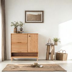 a living room with white walls and wooden furniture in the corner, along with plants