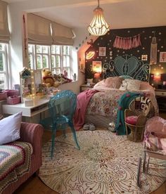 a bedroom decorated in pink, blue and white with lots of decor on the walls