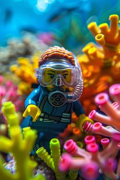 a lego man wearing a diving suit and goggles surrounded by colorful corals in the ocean