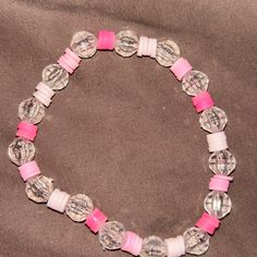 This Bracelet Is Made With Different Shades Of Pink Clay Beads And Clear Disco Beads Pink Crystal Bracelet With Letter Beads And Round Beads, Pink Crystal Bracelet With Letter Beads, Colorful Beaded Round Jewelry For Birthday, Silver Beaded Stretch Bracelet For Birthday, Clear Jewelry With Colorful Round Beads, Hypoallergenic Beaded Bracelets With Round Beads For Birthday, Beaded Round Bracelets For Birthday, Hypoallergenic Round Bead Bracelets For Birthday, Angel Pendant Necklace