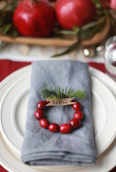 a red beaded bracelet sits on top of a napkin