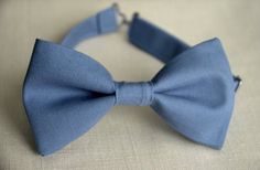 Your guy will look so handsome when he shows up wearing this dusty blue bow tie! Our cotton bow tie is a great choice for family photos, wedding, ring bearer outfit, birthday celebration or any other special occasion. **Please Specify Above** BOW TIE- clip-on style/or pre-tied style Baby: newborn- 1Y * Bow Tie: 3in wide Toddle: 2 years- 5 years Bow Tie: 3.5in wide Kids: 6years-12years * Bow Tie: 4in widel * Bow Tie: 5in RUSH MY ORDER- Please, contact us to be sere if your order will come on time Blue Bow Tie With Butterfly Knot For Formal Events, Dapper Blue Bow For Black Tie Events, Classic Blue Bow Tie With Butterfly Knot, Classic Blue Tie With Butterfly Knot, Classic Blue Bow With Butterfly Knot, Dapper Blue Satin Bow, Dapper Blue Tie With Satin Bow, Blue Bow With Butterfly Knot For Wedding, Blue Decorative Bow Standard Tie