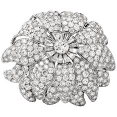 This meticulously crafted and versatile lapel brooch and pendant simulates an enchanting flower head with multiple petals rendered in solid platinum. With remarkable glitter, this exquisite monochromatic piece of jewelry is centered with a 0.70 carat genuine round brilliant-cut diamond graded F-G color and VVS clarity, secured by 4 prongs in a subtly elevated position. The sparkling center-stone is surrounded by 14 genuine tapered baguette diamonds, complemented by two layers of overlapping peta Diamond Flower Brooch, Antique Cushion Cut, Lapel Brooch, Antique Pins, Pendant Brooch, Pendant Diamond, Floral Brooch, Antique Brooches, Diamond Brooch