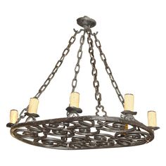 an iron chandelier with five lights hanging from the bottom and chain around it