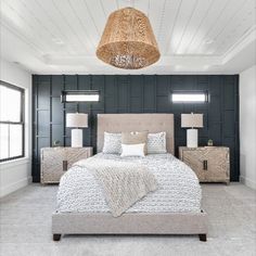 a bedroom with a bed, nightstands and lamps in it's center area