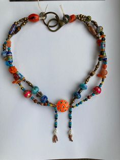 "Hand-tied double-strand beaded necklace. 16\", large easy-to-handle clasp. Beads include vintage, artisan glass, stone, Indonesian beads, meena beads, meena focal connector. Knotted on waxed linen." Adjustable Double Strand Bohemian Beaded Necklaces, Adjustable Double Strand Bohemian Beaded Necklace, Artisan Double Strand Beaded Necklaces, Artisan Double Strand Necklace With Colorful Beads, Handmade Artisan Double Strand Beaded Necklace, Adjustable Double Strand Beaded Festival Necklaces, Artisan Adjustable Double Strand Necklace, Adjustable Double Strand Beaded Necklaces For Festivals, Bohemian Czech Glass Spacer Beads