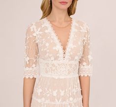 Soft and romantic details make this lace dress a feminine look. This A-line dress features a v-neckline, empire waist, and sheer elbow-length sleeves. Fully lined with nude fabric through the body, this dress is crafted from a sweet floral embroidered lace fabric. The soft skirt falls intiers and scalloped edging adds a delicate touch to the hems of this dress. A zipper closure at the center back closes this mid-length dress. Style this lace dress for the bride-to-be or on a night out with heels Nude Fabric, Soft Skirt, Embroidered Lace Fabric, Sweet Floral, Fall Skirts, Elbow Sleeve, Mid Length Dresses, Feminine Look, Elbow Length Sleeve