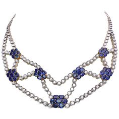 This necklace is designed with seven 18 karat yellow gold floral motifs , each set with seven oval Blue Sapphires. The necklace itself is bezel set round Brilliant Diamonds throughout, set in 18 karat white gold. The clasp at back is also another floral Blue Sapphire. The necklace is approximately 15" long. Round Diamonds = 8.78 carats Blue Sapphires = 16.56 carats Appraisal from Cellini Jewelers NYC upon request.