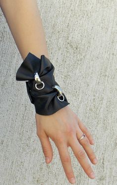 Black genuine leather bracelet with two accessories made of the finest metal. Versatile bracelet. Material: 100% leather The royal blue top in the pictures: https://www.etsy.com/listing/231569125/royal-blue-top-casual-blue-summer-blouse Black pants in the last picture: https://www.etsy.com/listing/231577440/black-leggings-black-rock-pants-black Black Leather Wrist Strap Bracelet For Party, Adjustable Leather Cuff Bracelet For Party, Leather Cuff Bracelets For Party, Leather Bangle Bracelet, Modern Leather Bracelet With Wrist Strap As Gift, Silver Leather Bracelets For Party, Modern Wristlet With Wrist Strap As Gift, Silver Leather Bangle Bracelet, Modern Black Leather Bracelet For Party