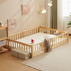 a baby's bed in the corner of a room with a rug on the floor