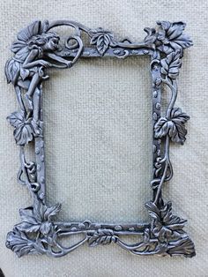 an ornate metal frame with flowers and vines