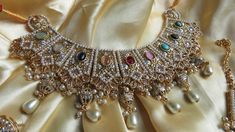 This elegant and gorgeous choker with matching earrings and tikka and is sure to be a hit for any event! The gorgeous multi and gold colors can match any outfit and the colors are gorgeous shades with a beautiful finish. Elegant Multicolor Kundan Lehenga, Elegant Multicolor Meenakari Lehenga, Elegant Multicolor Kundan Tikka, Multicolor Meenakari Bridal Necklace For Party, Multicolor Temple Jewelry Style Choker For Parties, Bollywood Style Multicolor Bridal Necklace With Zari Work, Multicolor Bridal Choker Necklace For Party, Multicolor Meenakari Lehenga For Party, Elegant Multicolor Festive Choker