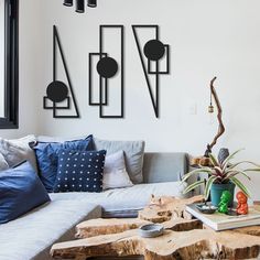 a living room filled with furniture and decor on top of a wooden table in front of a window