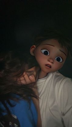 two young children are looking at something in the dark with their eyes wide open and one child has long brown hair