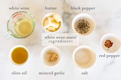 the ingredients to make white wine sauce are shown in small bowls on a marble countertop