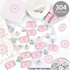 pink and white candy boxes with snowflakes on them, surrounded by other candies