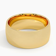 a yellow gold wedding ring on a white background