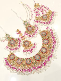 Most beautiful designer bridal set. Full complete set.   Earrings  Necklace Tikka Jhoomer Wedding Sets With Stone Work In Multicolor, White Meenakari Bridal Sets For Wedding, Multicolor Wedding Sets With Stone Work, Multicolor Wedding Set With Stone Work, Pink Kundan Necklace For Wedding With Intricate Design, Heavy Multicolor Wedding Sets, Heavy Pink Bridal Necklace For Wedding, Multicolor Lehenga With Stone Work For Wedding, Heavy Multicolor Bridal Sets For Wedding