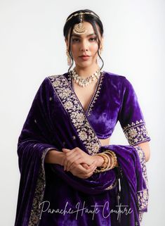 The violet color of lehenga set adds a regal touch, while the shawl can provide an additional layer of warmth and elegance. It is adorned with intricate embroidery, sequins, or other embellishments to make it stand out. When wearing a lehenga set, it's important to choose accessories that complement the outfit without overpowering it. A simple pair of earrings, a bracelet, and a clutch in a complementary color can be all that is needed to complete the look. Overall, a Violet Color Lehenga Set with a shawl from the Sensual Shadows Collection can be a stunning choice for anyone looking to make a statement with their fashion choices. The vibrant colors and intricate details are sure to turn heads and make the wearer feel like royalty. Brand: Panache Haute Couture Collection Name: The Sensual Complementary Color For Purple, Deep Purple Lehenga, Purple Pre-draped Saree For Wedding And Eid, Festive Purple Pre-draped Saree For Wedding, Purple Pre-draped Saree With Dupatta For Reception, Purple Pre-draped Saree For Wedding, Purple Pre-draped Saree With Zari Work For Reception, Bollywood Style Purple Pre-draped Saree For Wedding, Embroidered Purple Pre-draped Saree For Navratri