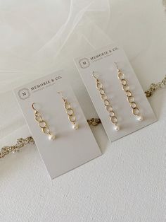 "Our elegant freshwater pearl dangle earrings are perfect for bridesmaids' gifts, bridal jewelry or for any occasion to dress up. Pearls measure approximately 4.5mm and fall from 14k gold filled links. The earrings are available in two lengths - 1 1/2\" or 2\". If you are ordering several pair and would like these individually boxed, please make a note in the comment section at checkout. Otherwise, they will be packaged in as few boxes as possible to avoid waste. About gold filled jewelry: Gold Pearl Chandelier Earrings With Pearl Chain As Gift, Gold Linear Earrings With Pearl Charm For Wedding, Minimalist Drop Linear Earrings For Wedding, Elegant Hypoallergenic Earrings For Mother's Day, Minimalist Wedding Linear Drop Earrings, Gold Dangle Pearl Earrings For Mother's Day, Elegant Pearl Charm Earrings For Wedding, Pearl White Chandelier Earrings With Pearl Charm As Gift, Elegant Drop Earrings For Mother's Day