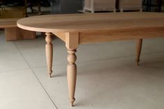 a wooden table sitting on top of a tiled floor