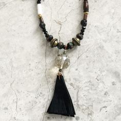 Long semi-precious stone bead necklace with healing and protective powers. Featuring black onyx for strength, prayer beads, bone, turquoise for protection, freshwater pearls for good health, black leather, rosewood, amethyst, jade for good luck, jasper, coral, Swarovski TM crystal beads, crystals and vintage findings. Black leather tassel. Comes in linen travel pouch. Each piece one of a kind and might vary slightly from picture. Meaures 40”. Handmade in USA. Spiritual Black Onyx Beaded Necklace, Spiritual Obsidian Beaded Jewelry, Bohemian Obsidian Jewelry For Healing, Spiritual Black Natural Stone Beads, Obsidian Beaded Jewelry For Healing, Unique Black Gemstone Beaded Necklaces, Black Gemstone Beaded Necklaces, Unique Black Beaded Necklaces With Gemstone Beads, Bohemian Obsidian Jewelry With Natural Stones