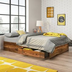 a bed sitting in a bedroom on top of a hard wood floor next to a window