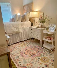 a bedroom with a bed, dresser and rug on the floor in front of it