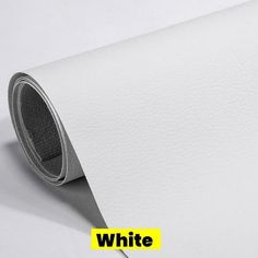 a white paper with the word white on it and a yellow sticker next to it