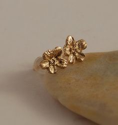 Detailed little 5 pedal blossom in a 14K gold post earrings. 1/4 across Yellow gold in stock now.  A great stud earring for someone who just likes Rose Gold Flower Earrings In 14k Gold, 14k Rose Gold Flower Earrings, 14k Gold Flower Earrings For Gift, Delicate 14k Gold Flower Earrings, Dainty Gold Earrings With 3d Flowers, Gold Flower Cluster Earrings Gift, Gold Flower Cluster Earrings For Pierced Ears, 14k Gold Flower Earrings For Wedding, Gold Flower Cluster Earrings