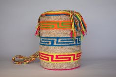 Mochila purse made by artisans of the Wayuu Indigenous Group in Colombia Purchased directly from Artisan, on a Fair Trade Basis Fully Handmade For each Wayuu Mochila Bag purchased, Hands of Colombia donates thread to Indigenous Artisans. Only ONE available Add a touch of indigenous craftsmanship to your style with our Hermos'aüi Wayuu Mochila Purse. Each purse is meticulously handmade by skilled artisans from the Wayuu Indigenous Group in Colombia. Hands of Colombia purchases each item in our Wa Multicolor Woven Bucket Bag As Gift, Multicolor Woven Bucket Bag Gift, Multicolor Handwoven Bucket Bag As A Gift, Traditional Handmade Multicolor Bucket Bag, Traditional Multicolor Woven Bucket Bag, Traditional Multicolor Handmade Bucket Bag, Artisan Handmade Multicolor Bucket Bag, Artisan Multicolor Handmade Bucket Bag, Traditional Multicolor Crochet Bag For Gift