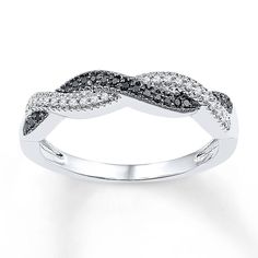 a white gold ring with black and white diamonds