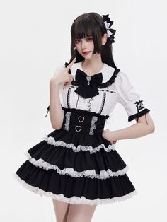 Embrace your inner edgy princess with our stunning gothic Lolita skirt. Adorned with heart-shaped buckles and delicate white lace, the high-waisted design features shirring at the back for a comfortable and flattering fit. The three layers of black fabric are accented with striking white ruffled lace trims, creating a dramatic and elegant look that's perfect for any alternative fashion enthusiast.   	 		 			Size 			S 			M 			L 		 		 			Full Length 			45 			46 			47 		 		 			Waist 			66-96 			70- Gothic Ruffled Corset For Cosplay, Gothic Ruffles Corset For Cosplay, Emo Mini Skirt For Costume Party, Gothic Lace Corset With Ruffles, Gothic Ruffled Mini Skirt For Cosplay, Gothic Fitted Mini Skirt With Ruffles, Fitted Gothic Mini Skirt With Ruffles, Gothic Ruffled Mini Skirt For Alternative Fashion, White Harajuku Style Ruffled Skirt