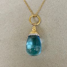 Created in 18 karat yellow gold  Blue Topaz 15 cts approx  Diamond 0.10 ct approx  18 kyg 18 inch chain with lobster lock  Chain can be worn at 17th inch    Handcrafted in 18K yellow gold, this necklace features a dazzling 15-carat blue topaz gemstone and a 0.10-carat diamond, all exquisitely embellished on an 18-inch kyg chain with a lobster-style clasp that enables it to be worn at a 17-inch length.    About the Designers ~ Dharmesh & Namrata    Drawing inspiration from little things, Dharmesh & Namrata Kothari have created an extraordinary and refreshing collection of luxurious jewels. True believers of destiny, they always feel that the possibilities of design - and life - are limitless when people work together. Formed in 2003, Syna Jewels has grown through enduring relationships with Formal Blue Topaz Drop Necklace, Formal Blue Topaz Briolette Necklace, Blue Diamond Briolette Necklace, Yellow Gold Briolette Blue Topaz Jewelry, Yellow Gold Blue Topaz Briolette Jewelry, Yellow Gold Teardrop Blue Topaz Necklace, Blue Topaz Briolette Necklace In Fine Jewelry Style, Gold Necklace With Blue Topaz Briolette, Fine Jewelry Blue Topaz Briolette Necklace