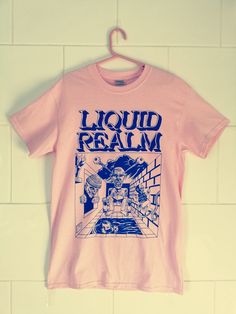 T-Shirt featuring the front cover artwork from the hit small press comic book by Samuel Hickson.  Blue ink screen printed on Gildan heavy pink T-shirt. Pink Tshirt Design Ideas, Pink Pop Culture T-shirt With Screen Print, Pink Graffiti Print T-shirt For Streetwear, Pink Front Print T-shirt For Streetwear, Pink Graphic Design T-shirt For Fan Merchandise, Pink Cotton T-shirt With Graffiti Print, Pink Shirt Design, Merch Design, Red Tee