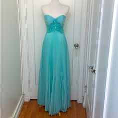 Beautiful Aqua Marine Colored Strapless Gown With Rhinestones And Beads With Back Zip. Top Closes But Dress Is Too Small For Mannequin. Nwot And Never Worn. Pleated Skirt Is Flowy And Elegant. Embellished Floor-length Strapless Evening Dress, Embellished Floor-length Strapless Dress For Evening, Strapless Rhinestone Prom Evening Dress, Blue Prom Gown With Rhinestones, Formal Gown With Rhinestones And Sweetheart Neckline, Blue Rhinestone Gown For Prom Season, Blue Floor-length Strapless Dress For Prom, Blue Rhinestone Evening Gown, Blue Strapless Embellished Evening Dress