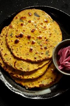 some food is on a black plate and ready to be eaten