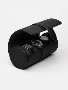 The Watch Roll is the ideal extension for any traveller who enjoys bringing their timepieces on adventures. It has a removable cushion to keep up to three watches safe and secure when on the go or at home. We've included a removable leather divider to avoid any unwanted impact. The elegant case in leather and soft microfiber packs a small size, meaning it easily slips into any bag - big or small.     The watch roll is made by hand in Ubrique, Spain. Luxury Leather Watch Accessories, Black Watch With Round Case For Everyday Use, Modern Leather Watches With Round Case, Luxury Leather Watch Accessories For Outdoor, Black Leather Travel Watch, Travel Watch Accessories With Round Case, Timeless Rectangular Watch For Travel, Luxury Black Watch Band For Everyday Use, Luxury Automatic Watch Accessories For Travel