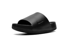 The Nike Calm Slide "Black" is a versatile, monochromatic black colorway of the comfortable slip-on sandal.  Designed for post activity wear, the Calm Slide debuted in 2023 in several appealing colorways, including in this easy-to-style “Black” design.  The sandal is constructed from a black one-piece foam mold.  The midfoot strap that supports the sandal features a debossed Swoosh on the side.  Underneath, a thick foam cushioning footbed provides a comfortable ride. Stadium Goods, Black One Piece, The Calm, Slide In, All Brands, Black Design, Nike Logo, Slip On Sandal, Black Shoes