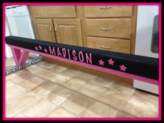 a pink bench with black and white stars on it in front of a kitchen counter