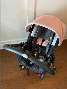 a baby stroller sitting on top of a hard wood floor