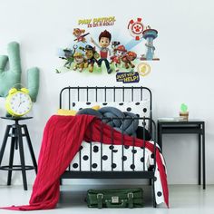 a bedroom with toy story wall stickers on the walls and a bed in front