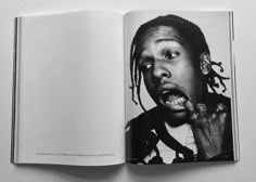 an open book with a black and white photo of a man's face on it