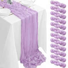 the table is set with purple napkins and place settings