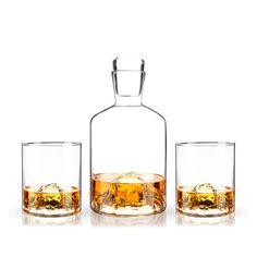 two glasses and a decante bottle with ice in them on a white background photo